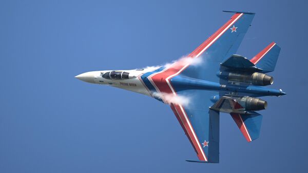 A member of the Russian Knights (Russikiye Vityazi), Russian Air Force aerobatic display team flying Sukhoi SU-35S and Su-30SM fighters, at the opening ceremony of the International Military-Technical Forum ARMY-2022 in Kubinka. - Sputnik International