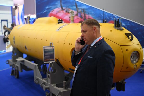 A visitor talks on the phone near a model submarine at the exhibition held as part of the International Military-Technical Forum ARMY-2022 at the Patriot Congress and Exhibition Center. - Sputnik International