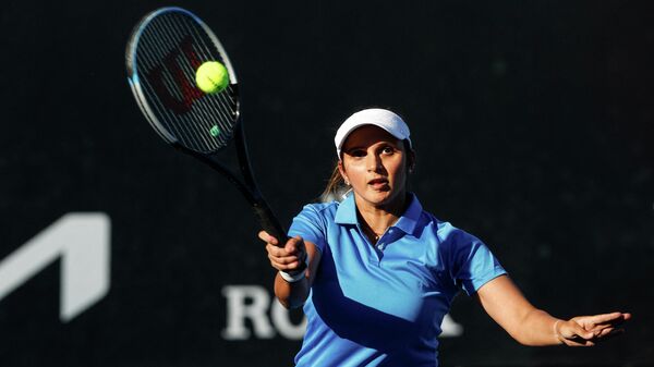 India's Sania Mirza hits a return as she plays with partner Rajeev Ram of the US against Serbia's Aleksandra Krunic and Nikola Cacic during their mixed doubles match on day four of the Australian Open tennis tournament in Melbourne on January 20, 2022. - Sputnik International