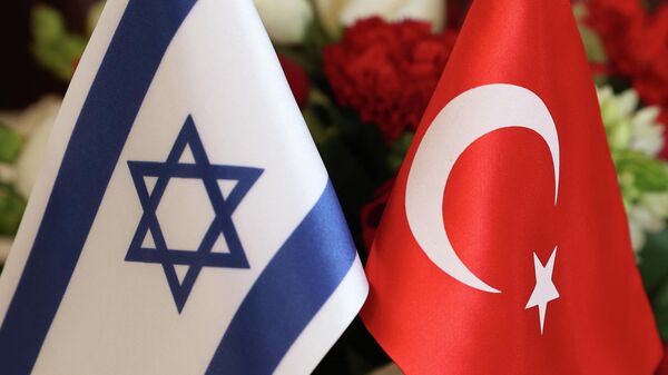 The Turkish (R) and Israeli flags are pictured before a meeting between the Turkish Foreign Minister Mevlut Cavusoglu and Israeli businessmen, in the coastral city of Tel Aviv, on May 25, 2022. - Cavusoglu is on a visit to Israel and the occupied-West Bank to meet with Israeli and Palestinian officials. (Photo by JACK GUEZ / AFP) - Sputnik International