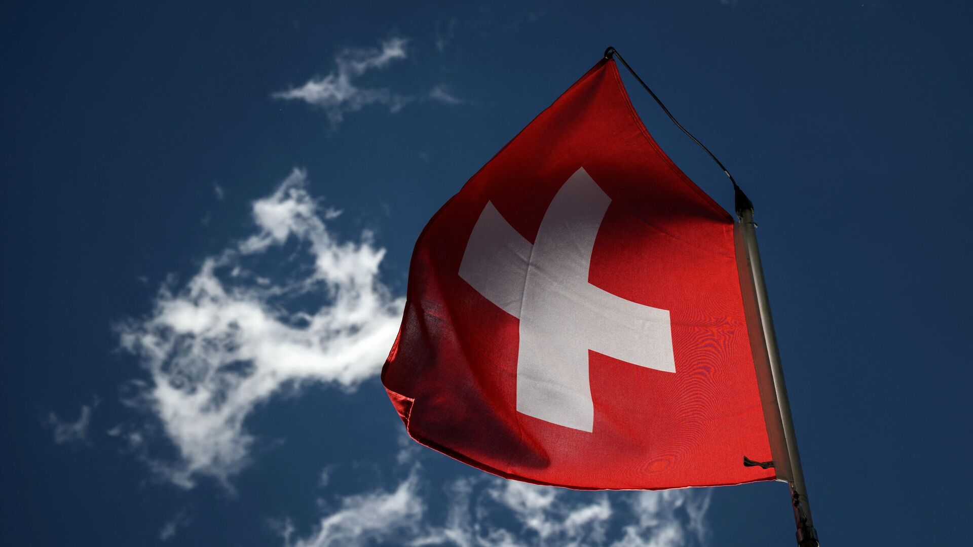 A Swiss national flag flutters in a blue sky in Bourg-Saint-Pierre, western Switzerland on June 21, 2022.  - Sputnik International, 1920, 06.09.2022