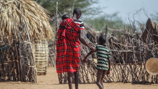 A father helps his malnourished son to walk near their hut in the village of Lomoputh in northern Kenya Thursday, May 12, 2022. United Nations Under-Secretary-General for Humanitarian Affairs Martin Griffiths visited the area on Thurs - Sputnik International