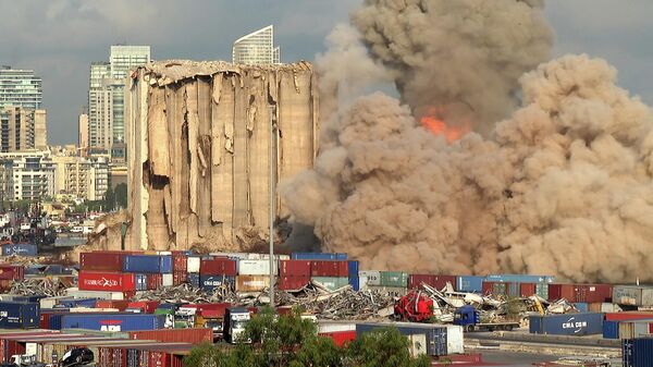 This grab from AFPTV footage shot on August 23, 2022 shows a smoke plume rising after the new collapse of the northern section of the grain silos at the port of Lebanon's capital Beirut, which were previously partly destroyed by the 2020 port explosion - Sputnik International