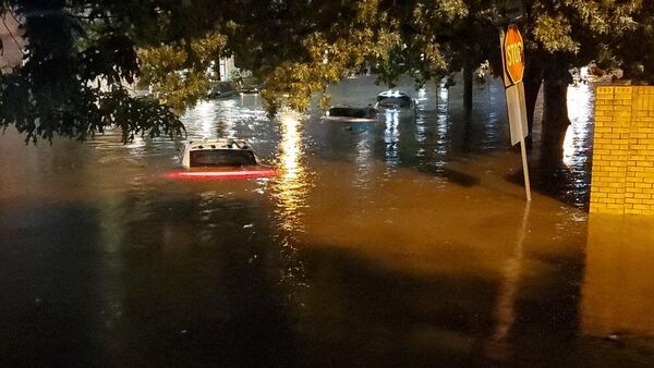 This handout photo provided by the Dallas Police Department on August 22, 2022, shows vehicles sitting in flood waters along a street in Dallas, Texas - Sputnik International