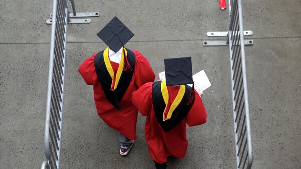 FILE - New graduates walk into the High Point Solutions Stadium before the start of the Rutgers University graduation ceremony in Piscataway Township, N.J., on May 13, 2018 - Sputnik International