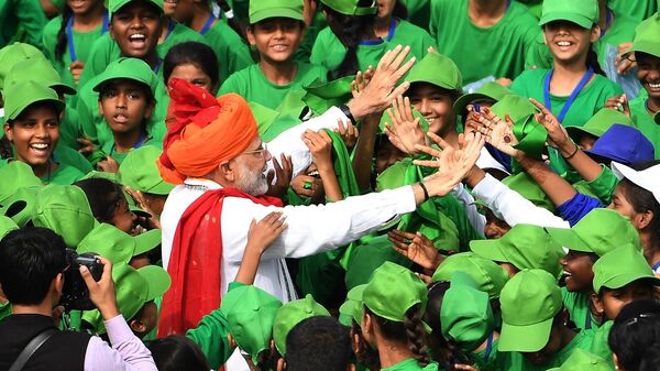 Indian Prime Minister Narendra Modi greets schoolchildren after his speech as part of India's 72nd Independence Day celebrations, which marks the 71st anniversary of the end of British colonial rule, at the Red Fort in New Delhi on August 15, 2018 - Sputnik International