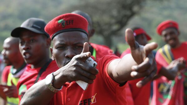 A protester gestures, as supporters of South Africa's leftist opposition party, the Economic Freedom Fighters, gather in Phoenix, South Africa, Thursday, Aug. 5, 2021, during a demonstration against the killings of 36 people in Phoenix, a suburb of Durban, during the recent violent riots in KwaZulu-Natal province. More than 1,000 people marched through Phoenix to hand police a statement demanding justice for the families of those who were killed in that town during the violence. (AP Photo) - Sputnik International