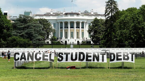 As college students around the country graduate with a massive amount of debt, advocates display a hand-painted sign on the Ellipse in front of The White House to call on President Joe Biden to sign an executive order to cancel student debt on June 15, 2021 in Washington, DC.  - Sputnik International