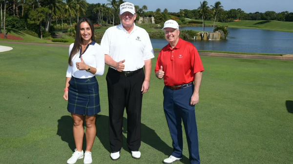 Inna Yashchyshyn poses with former President Donald Trump and Sen. Lindsey Graham, R-S.C., at Mr. Trump’s private golf course just miles from Mar-a-Lago in May 2021. - Sputnik International