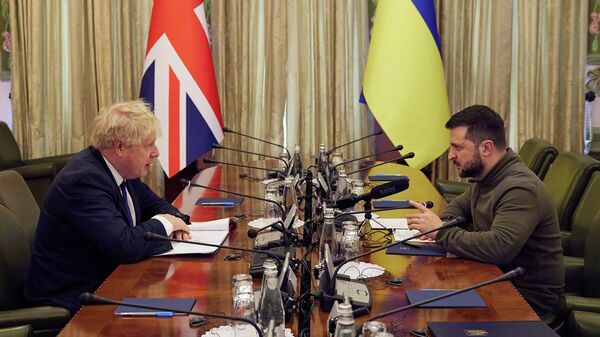 In this image provided by the Ukrainian Presidential Press Office, Ukrainian President Volodymyr Zelenskyy, right, and Britain's Prime Minister Boris Johnson speak, during their meeting in Kyiv, Ukraine, Saturday, April 9, 2022.  Johnson has traveled to Ukraine to meet with President Volodymyr Zelenskyy in show of solidarity. The two leaders meeting Saturday discussed the “U.K.’s long term support to Ukraine’’ including a new package of financial and military aid, the prime minister’s office said.  (Ukrainian Presidential Press Office via AP) - Sputnik International