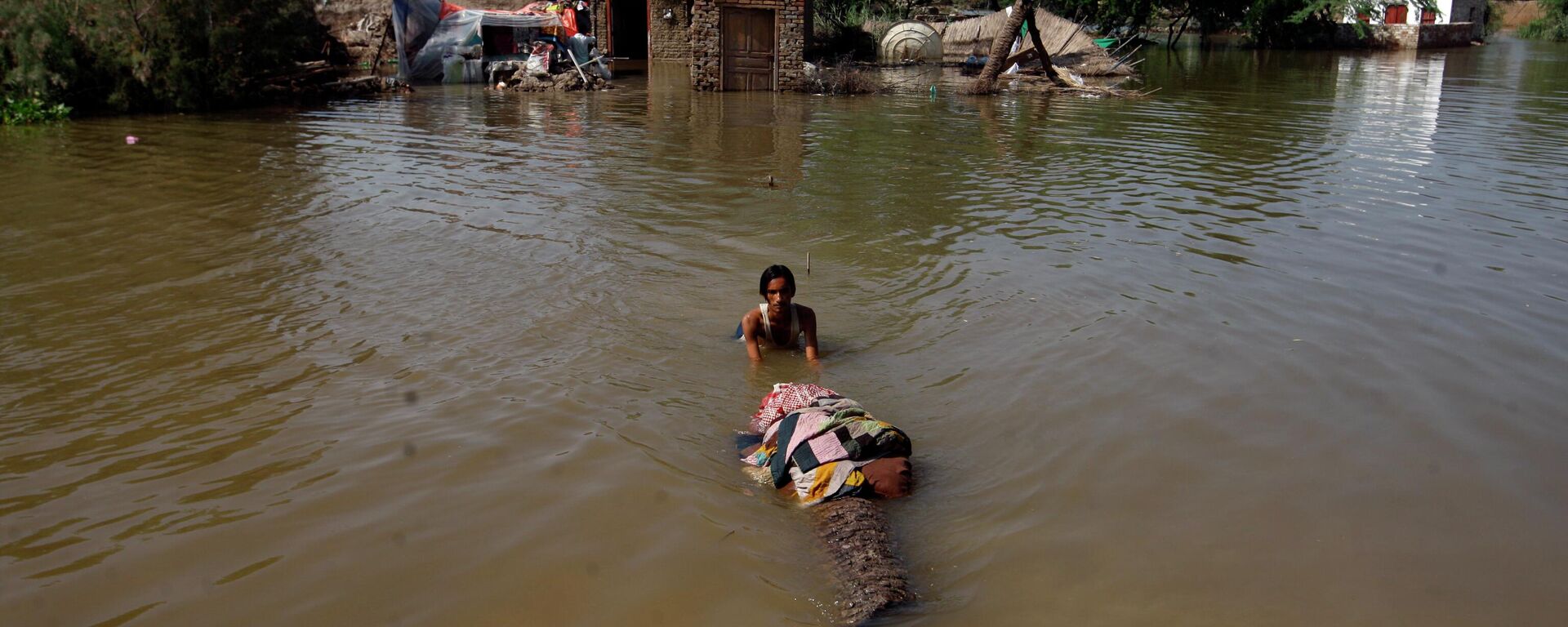 A man carries salvageable belongings from his flood-hit home in Shikarpur district of Sindh province, of Pakistan, Wednesday, Aug. 31, 2022 - Sputnik International, 1920, 31.08.2022