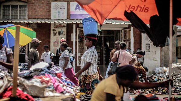 People shop at an open air market on Patrice Lumumba road in Lusaka. File photo - Sputnik International