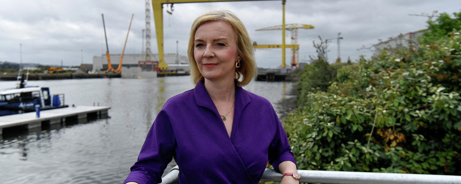 In this file photo taken on August 17, 2022 Contender to become the country's next Prime minister and leader of the Conservative party British Foreign Secretary Liz Truss (C) poses for a photograph with the Harland and Wolff shipyard cranes at a Conservative Party leadership campaign event, at Artemis Technologies in Belfast Harbour, Belfast - Sputnik International, 1920, 06.09.2022