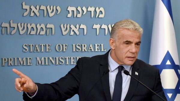 Israeli Prime Minister Yair Lapid speaks about Iran at a security briefing for the foreign press at the Prime Minister's office in Jerusalem, Wednesday, Aug. 24, 2022. Lapid called on U.S. President Joe Biden and Western powers to call off an emerging nuclear deal with Iran, saying an agreement would fail to prevent Iran from developing a nuclear bomb and reward it with billions of dollars to fund Israel's enemies. Israel's caretaker prime minister used stark language on Wednesday in his criticism of the expected agreement. (Debbie Hill/Pool via AP) - Sputnik International