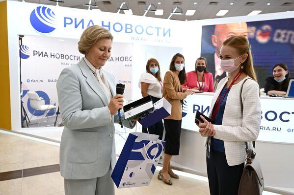 Head of the Russian Federal Service for Surveillance on Consumer Rights Protection and Human Welfare Anna Popova (left) at the Rossiya Segodnya media group stand at the Eastern Economic Forum in Vladivostok. - Sputnik International