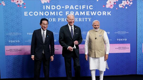 Japanese Prime Minister Fumio Kishida, left, President Joe Biden and Indian Prime Minister Narendra Modi pose for photos as they arrive at the Indo-Pacific Economic Framework for Prosperity launch event at the Izumi Garden Gallery, Monday, May 23, 2022, in Tokyo. - Sputnik International
