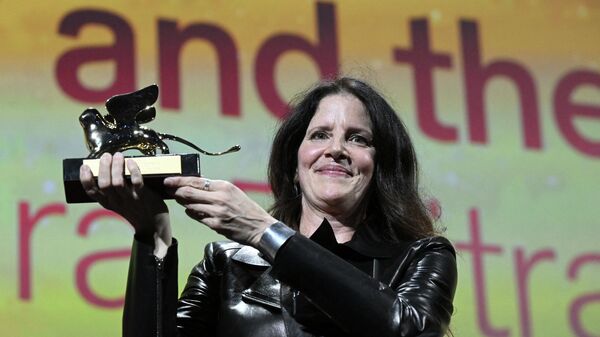 US director Laura Poitras acknowledges receiving the Golden Lion for Best Film for All the Beauty and the Bloodshed on September 10, 2022 during the closing ceremony of the 79th Venice International Film Festival at Lido di Venezia in Venice, Italy. - Sputnik International