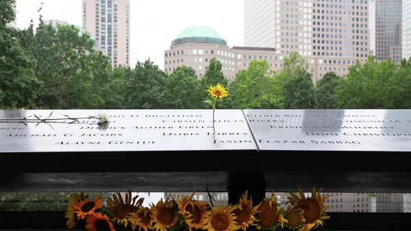 Sunflowers are seen on the names of victims of the 9/11 terror attack on the North Tower Memorial Pool during the annual 9/11 Commemoration Ceremony at the National 9/11 Memorial and Museum on September 11, 2022 in New York City. - Sputnik International