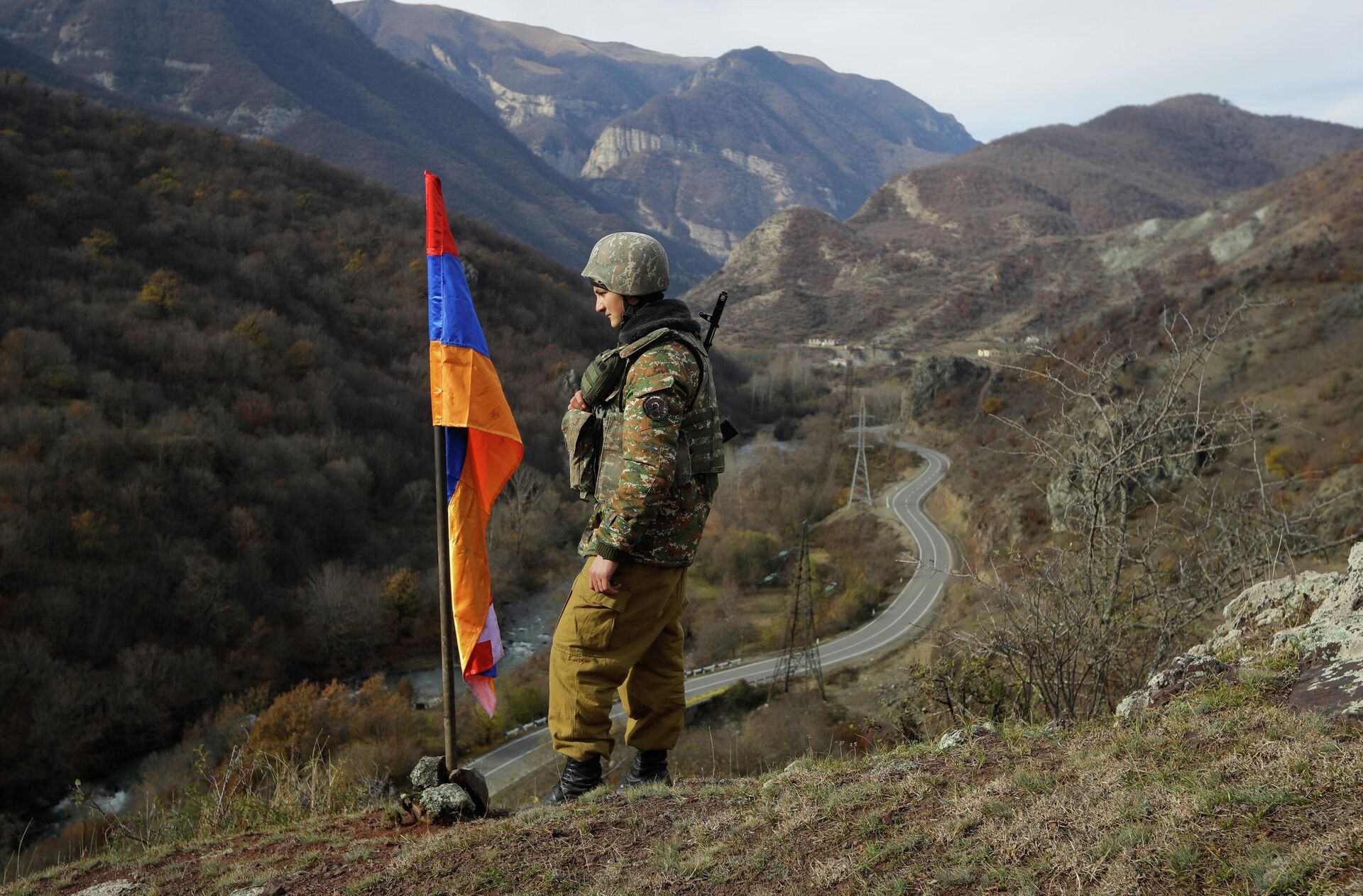 FILE - In this Wednesday, Nov. 25, 2020 file photo, An ethnic Armenian soldier stands guard next to Nagorno-Karabakh's flag atop of the hill near Charektar , Nov. 25, 2020 - Sputnik International, 1920, 20.09.2023