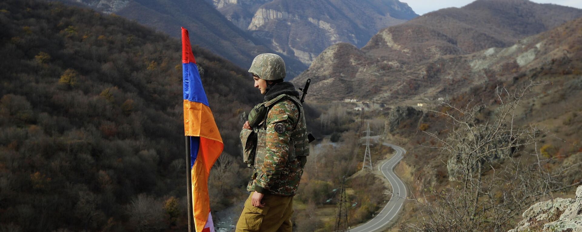 FILE - In this Wednesday, Nov. 25, 2020 file photo, An ethnic Armenian soldier stands guard next to Nagorno-Karabakh's flag atop of the hill near Charektar , Nov. 25, 2020 - Sputnik International, 1920, 20.09.2023