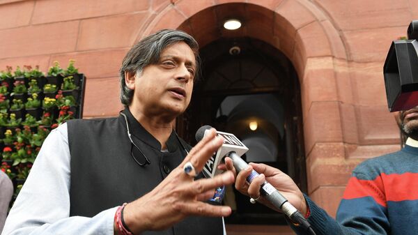 Indian Congress party leader Shashi Tharoor gestures as he talks to a media representative on the first day of the winter session of the parliament in New Delhi on December 11, 2018 - Sputnik International