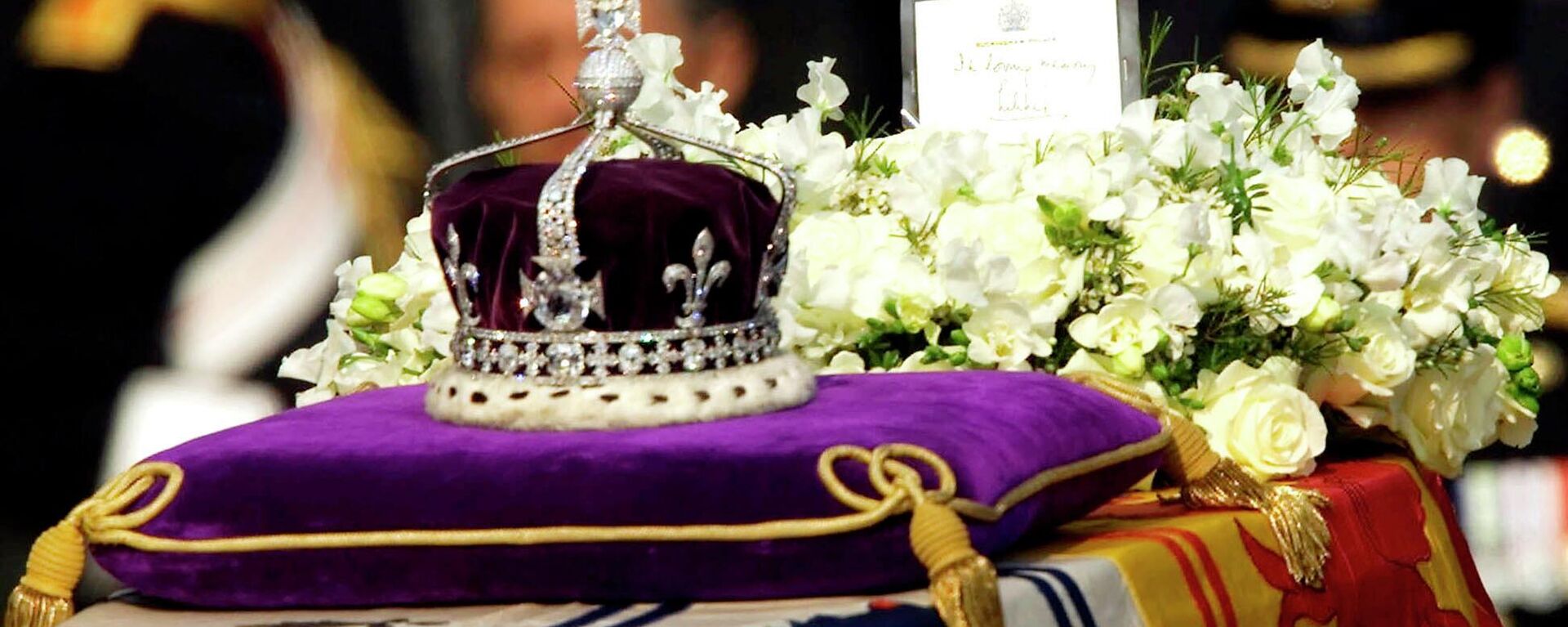 FILE - The Koh-i-noor, or mountain of light, diamond, set in the Maltese Cross at the front of the crown made for Britain's late Queen Mother Elizabeth, is seen on her coffin, along with her personal standard, a wreath and a note from her daughter, Queen Elizabeth II, as it is drawn to London's Westminster Hall in this April 5, 2002. Hundreds of thousands of people are expected to flock to London’s medieval Westminster Hall from Wednesday, Sept. 14, 2022, to pay their respects to Queen Elizabeth II, whose coffin will lie in state for four days until her funeral on Monday. (AP Photo/Alastair Grant, File) - Sputnik International, 1920, 16.09.2022