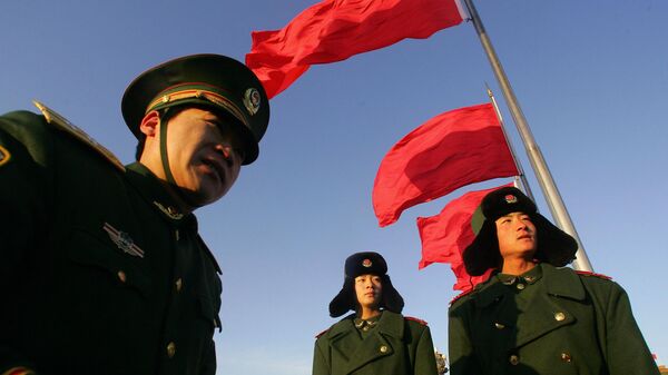Paramilitary soldiers march beneath red flags on Tiananmen Square for the opening session of China's annual parliament, the National People's Congress (NPC), 05 March 2007 at the Great Hall of the People in Beijing - Sputnik International