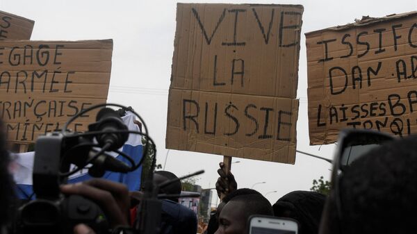 A man holds a placard reading Long live Russia as people demonstrate against French military presence in Niger on September 18, 2022 in Niamey. - French forces first intervened in the Sahel's jihadist emergency in 2013, sending troops to support Malian forces fighting a regional insurgency.
It widened the effort a year later with Operation Barkhane, eventually deploying some 5,100 troops, warplanes and drones in former colonies Chad, Burkina Faso, Mali, Mauritania and Niger.  - Sputnik International