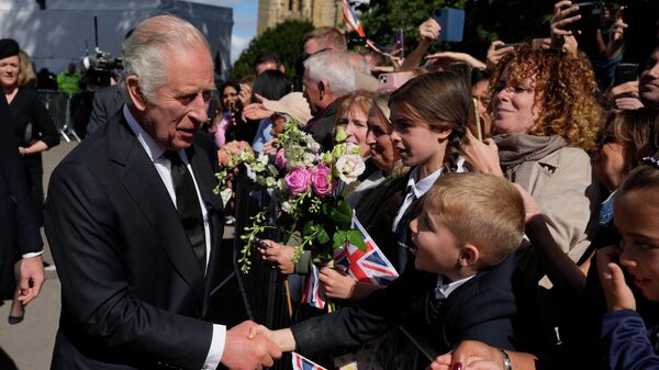 Britain's King Charles III shakes hands with a boy after a Service of Prayer and Reflection for the life of Queen Elizabeth II, at Llandaff Cathedral in Cardiff, Wales, Friday Sept. 16, 2022. The Royal couple has have arrived in Wales for an official visit. The royal couple previously visited to Scotland and Northern Ireland, the other nations making up the United Kingdom, following the death of Queen Elizabeth II at age 96 on Thursday, Sept. 8. (AP Photo/Frank Augstein, Pool) - Sputnik International