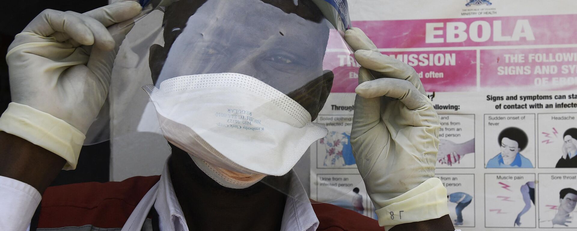 A health worker puts on protective gears as he prepares to screen travellers at the Mpondwe Health Screening Facility in the Uganda's border town of Mpondwe as they cross over from the Democratic Republic of Congo, on June 13, 2019. - Sputnik International, 1920, 22.09.2022