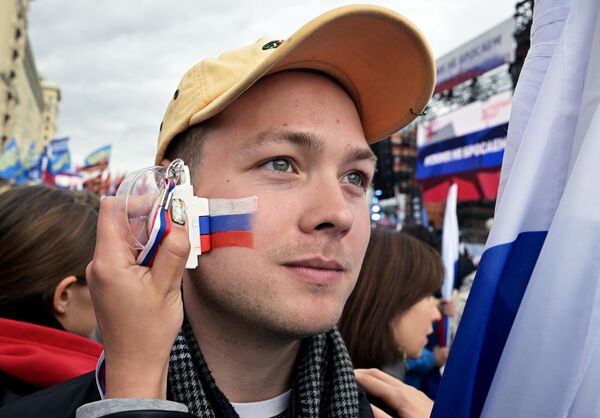 A young man attends the &quot;We Don&#x27;t Abandon Our Own&quot; rally on Manezhnaya Square in Moscow. - Sputnik International