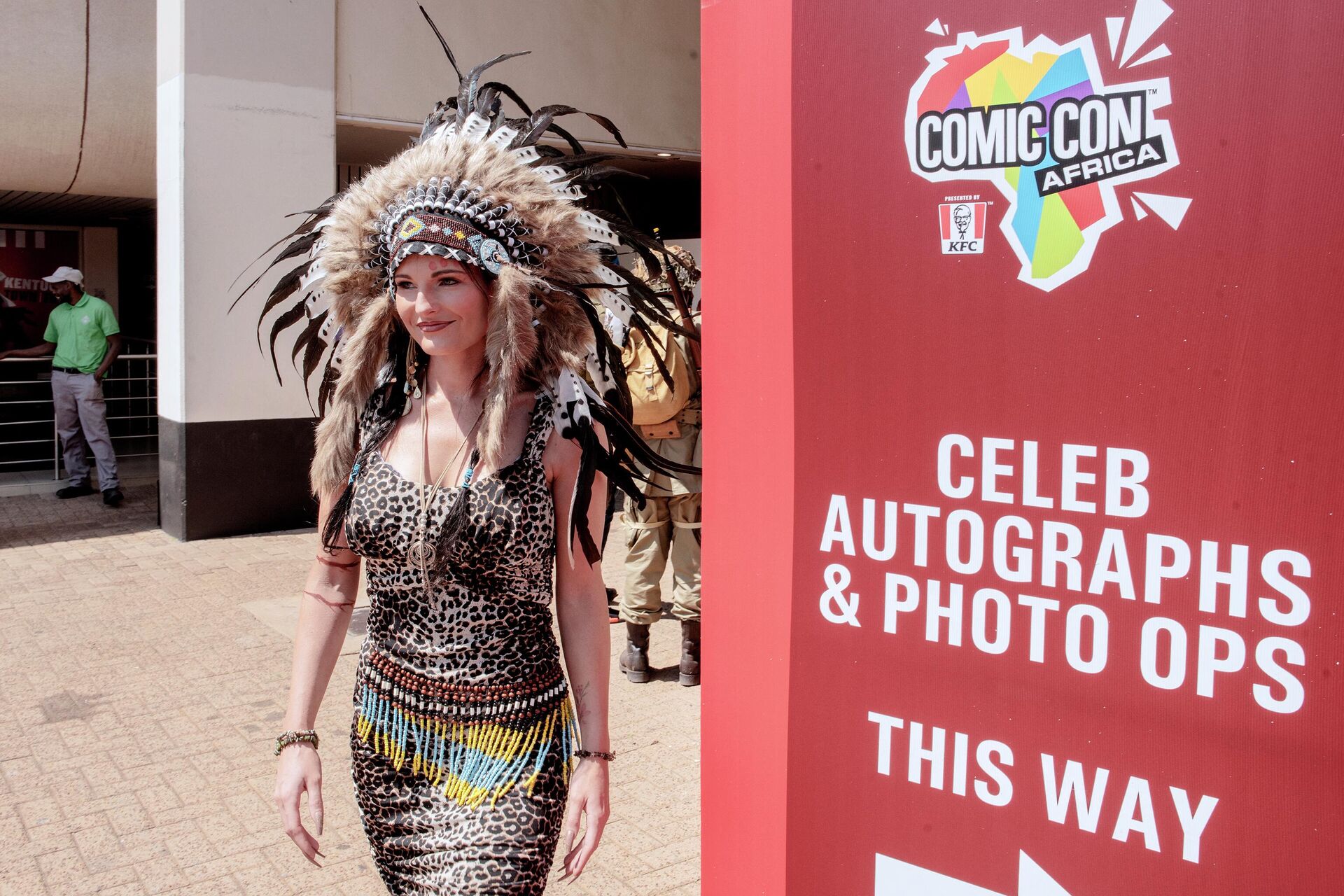 A woman walks in front of the main entrance of Comic Con Africa, the largest pop colture, fantasy and gaming festival of the Continent, as she dresses a costume representing Pocahontas, at the Nasrec Expo Centre, Johannesburg, on September 23, 2022. (Photo by LUCA SOLA / AFP) - Sputnik International, 1920, 25.09.2022
