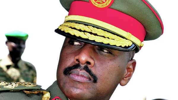 The son of Uganda's President Yoweri Museveni, Major General Muhoozi Kainerugaba attends a ceremony in which he was promoted from Brigadier to Major General at the country's military headquarters in Kampala on May 25, 2016. - The son of Uganda's President Yoweri Museveni, one of Africa's longest-serving leaders, has rejected claims that he plans to succeed his father, reports said Thursday. Muhoozi Kainerugaba, speaking on May 25 after he was promoted from Brigadier to Major General, heading the Special Forces Command (SFC), said he was happy with being in the military, the government-owned New Vision newspaper reported. (Photo by PETER BUSOMOKE / AFP) - Sputnik International