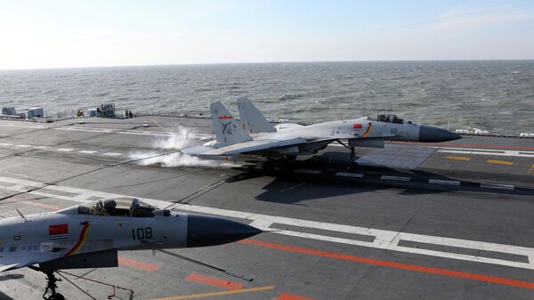 This picture taken on an undisclosed date in December 2016 shows a Chinese J-15 fighter jet landing on the deck of the Liaoning aircraft carrier during military drills in the Bohai Sea, off China's northeast coast - Sputnik International