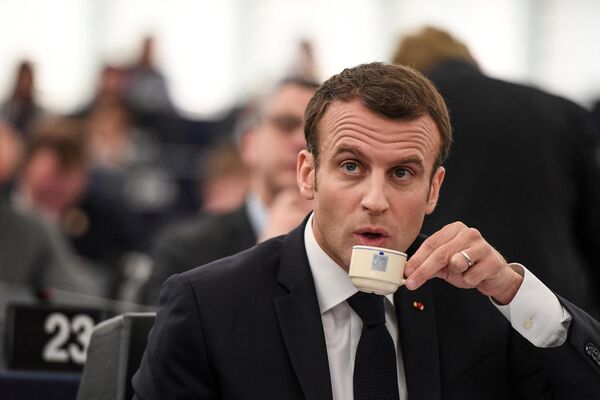 French President Emmanuel Macron drinks coffee as he sits after a speech at the European Parliament on 17 April 2018 in the eastern French city of Strasbourg. - Sputnik International