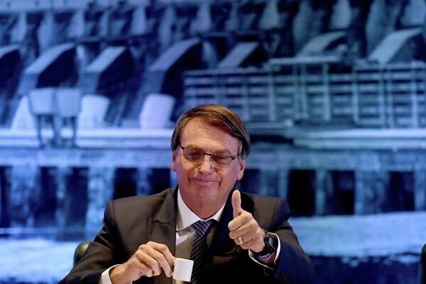 Brazilian President Jair Bolsonaro gestures as he drinks coffee during a ceremony in which the director general of the Itaipu Binacional hydroelectric power plant, Anatalicio Risden (out of frame), took office, at the Itamaraty Palace in Brasilia, on 22 February 2022. - Sputnik International
