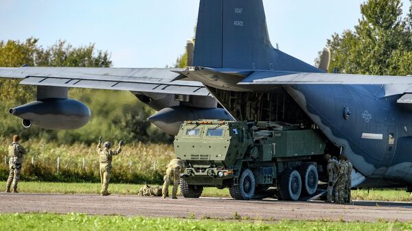 Soldiers load a High-Mobility Artillery Rocket System (HIMARS ) from a US Special Operations MC-130J aircraft during military exercises at Spilve Airport in Riga, Latvia, on Sept. 26, 2022. - Sputnik International