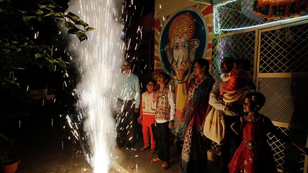 People play with fireworks during Diwali, the festival of lights, in Prayagraj, India, Sunday, Oct. 27, 2019. Hindus across the country are celebrating Diwali where people decorate their homes with light and burst fireworks. - Sputnik International