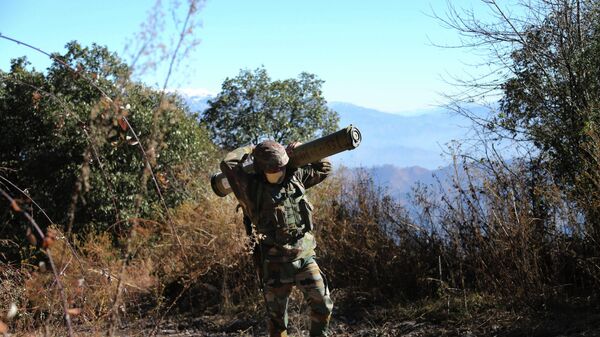 In this Dec.18, 2020, file photo, an Indian army soldier carries an anti-tank guided missile (ATGM) to his base between India and Pakistan border on the forward post of Balakot, in Poonch, about 250 kilometers (156 miles) from Jammu, India. - Sputnik International