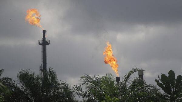 Gas flares belonging to the Agip Oil company are seen across farmland in Idu, Niger Delta area of Nigeria, Friday, Oct. 8, 2021. - Sputnik International