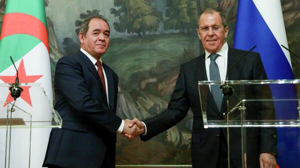 In this photo distributed by Russian Foreign Ministry Press Service, Russian Foreign Minister Sergey Lavrov, right, and Algerian Foreign Minister Sabri Boukadoum shake hands as they leave a joint news conference following their talks in Moscow, Russia on Wednesday, July 22, 2020. - Sputnik International