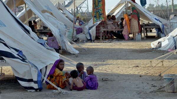 Children play outside their tent at a relief camp, in Jaffarabad, a district in the southwestern Baluchistan province, Pakistan, Thursday, Sept. 29, 2022. - Sputnik International