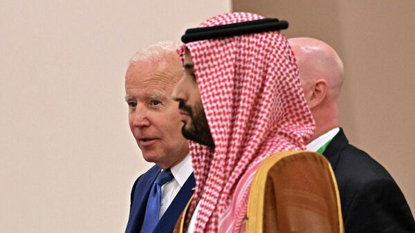 US President Joe Biden (behind) and Saudi Crown Prince Mohammed bin Salman (front) arrive for the family photo during the Jeddah Security and Development Summit (GCC+3) at a hotel in Saudi Arabia's Red Sea coastal city of Jeddah on July 16, 2022.  - Sputnik International