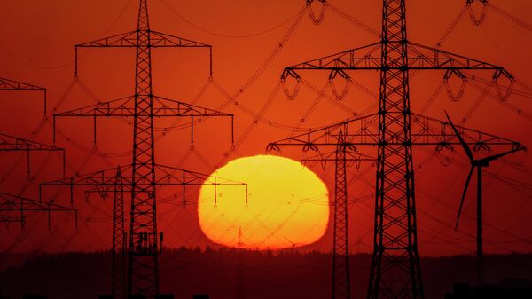 The sun rises behind power poles on the outskirts of Frankfurt, Germany, on May 15, 2022.  - Sputnik International