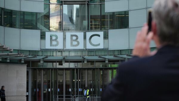 A man takes a photo of the BBC Headquarters in London, Tuesday, Oct. 18, 2022 as the BBC celebrates 100 years of broadcasting. - Sputnik International