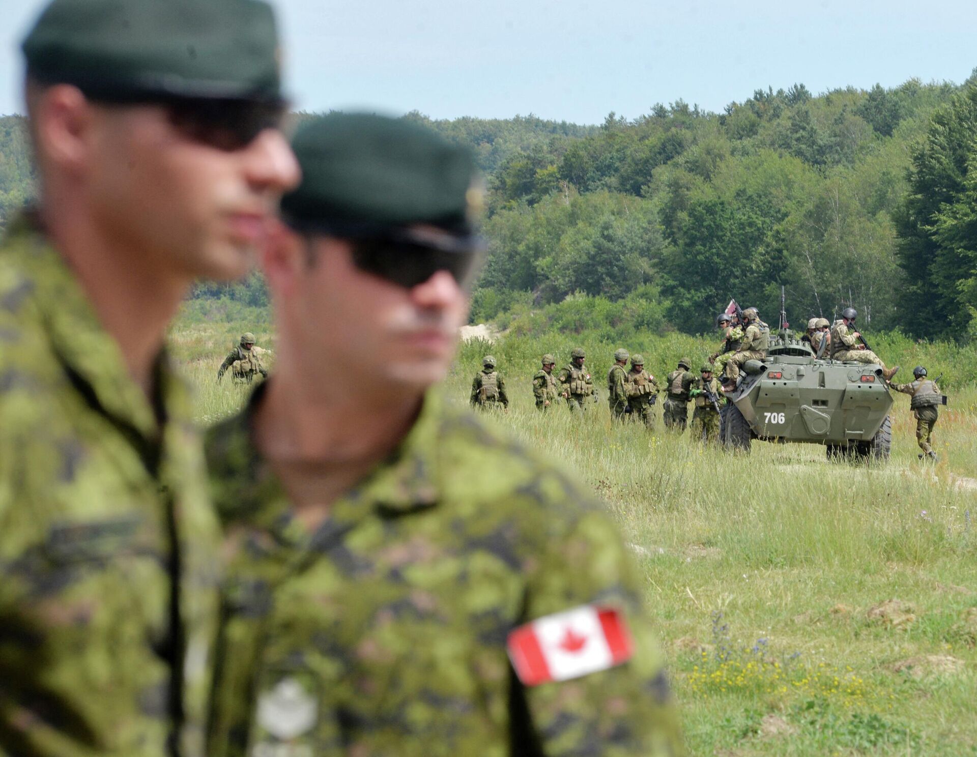 Canadian military instructors look on during Ukrainian military exercises at the International Peacekeeping and Security Center in Yavorov, near Lvov, on July 12, 2016 - Sputnik International, 1920, 23.10.2022