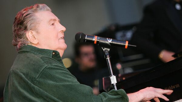 In this file photo taken on October 11, 2006 US music legend Jerry Lee Lewis gives a rare live performance for fans in support of his newest studio album Last Man Standing  outside the Virgin Megastore at Hollywood and Highland in the Hollywood section of Los Angeles, California. - Sputnik International