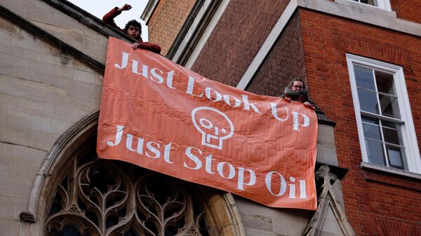 Activists from the Just Stop Oil campaign group protest against the use of oil after the arrivals for the BAFTA British Academy Film Awards at the Royal Albert Hall, in London, on March 13, 2022. - Sputnik International