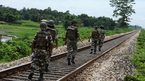 Indian paramilitary forces patrol along the railways tracks at Mojati village at Kokrajhar district in the northeastern state of Assam on July 26, 2012 - Sputnik International