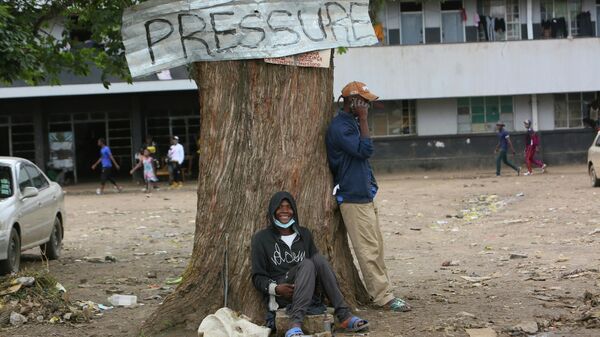 Two men relax under a tree in a poor township on the outskirts of the capital Harare, Tuesday, Nov, 16, 2021.  - Sputnik International